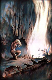 A blonde woman trying to warm herself at a firepit.